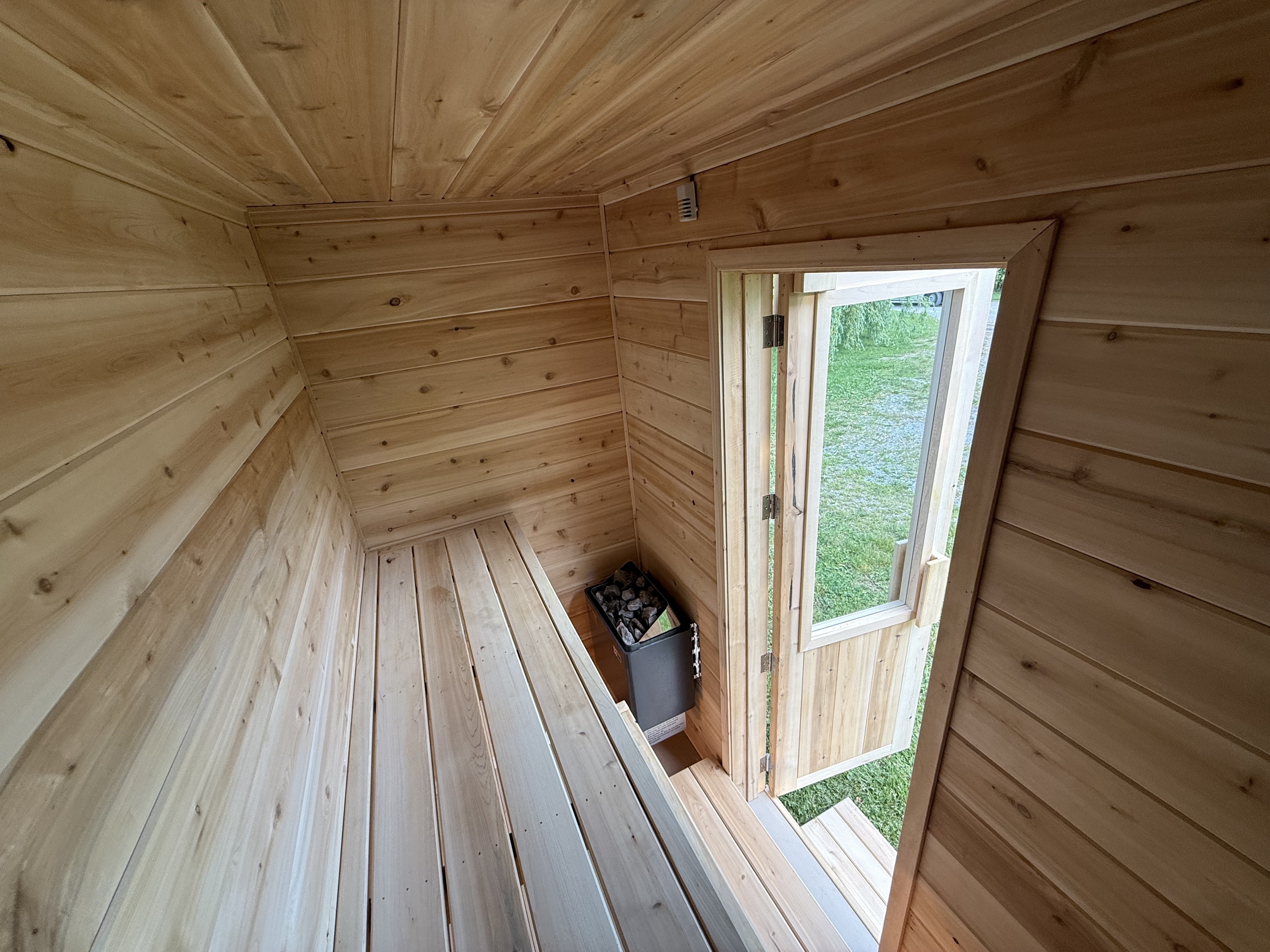 Interior view of sauna showing electric heater and bench